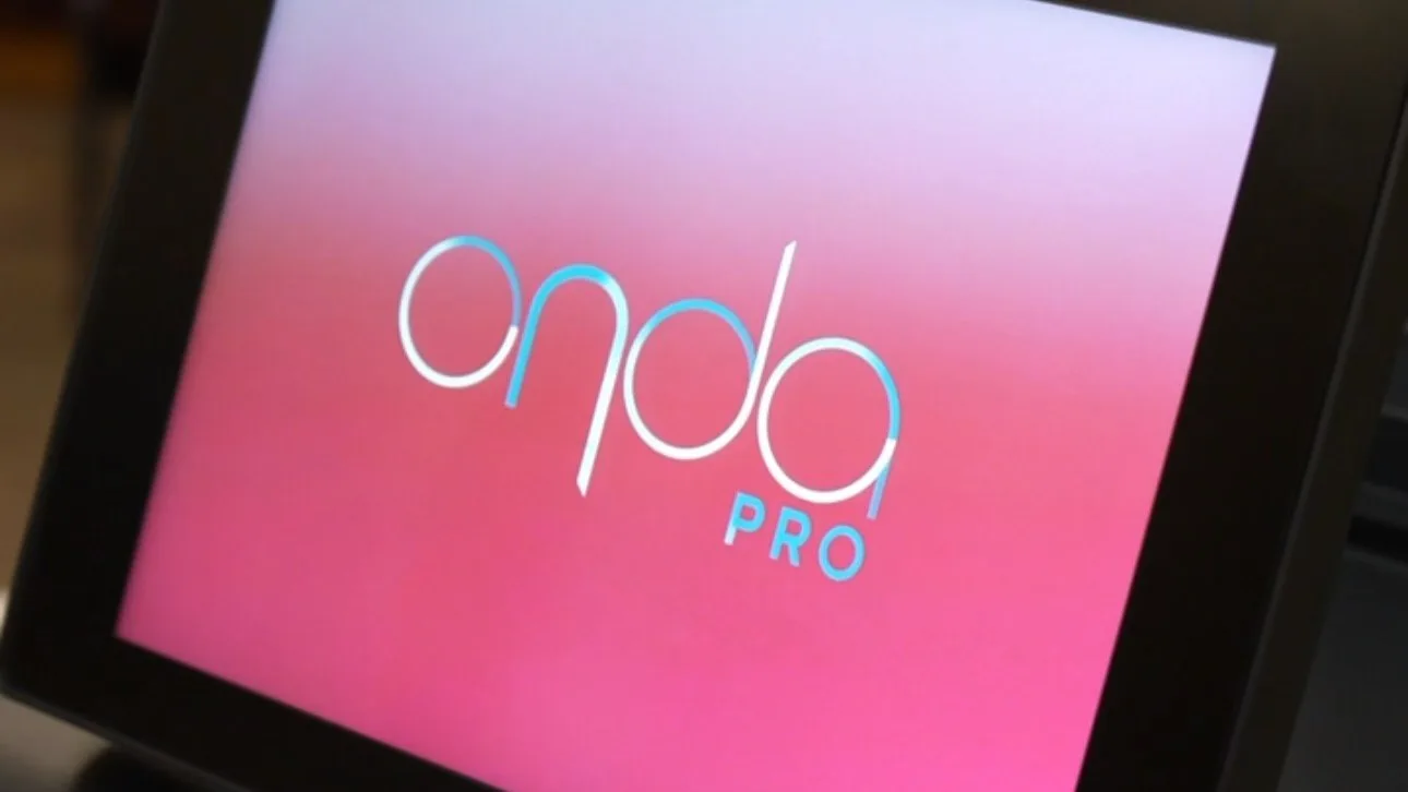 The ONDA Pro Coolwaves console, its touchscreen showing the device logo, in a treatment room at Reviv Med Spa in Millbrae, California