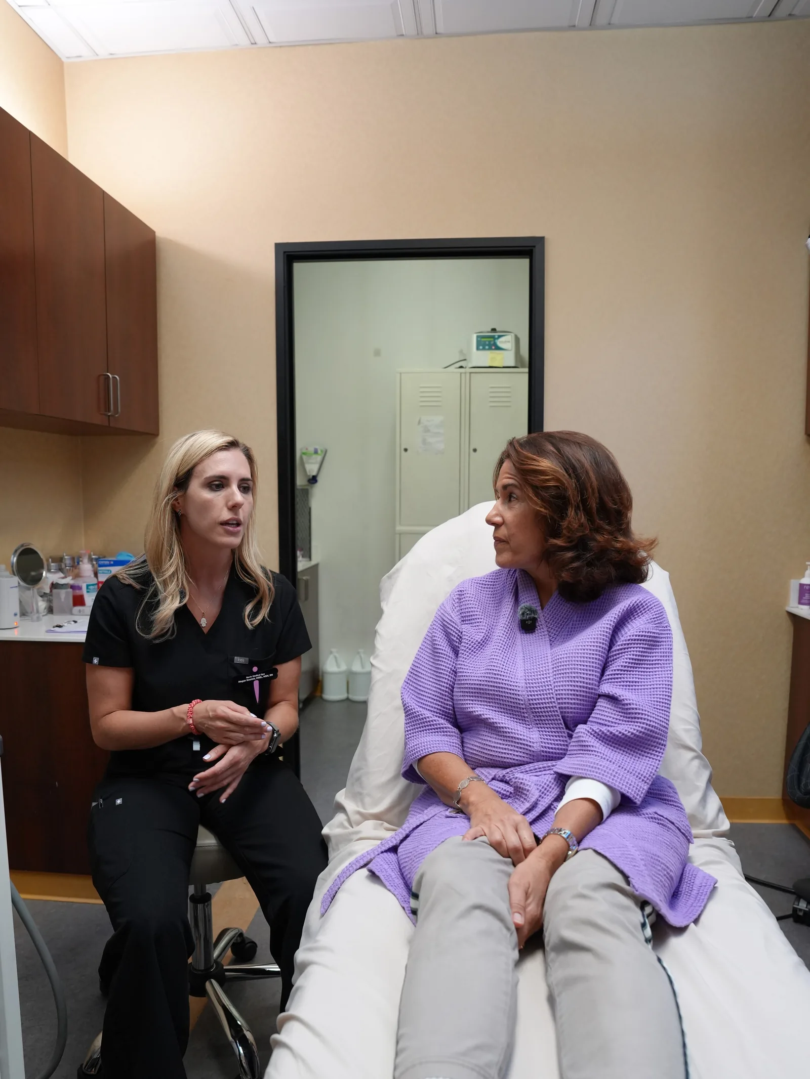Megan Sosnick in consultation with a patient in the treatment room before vein therapy at Reviv Med Spa, Millbrae